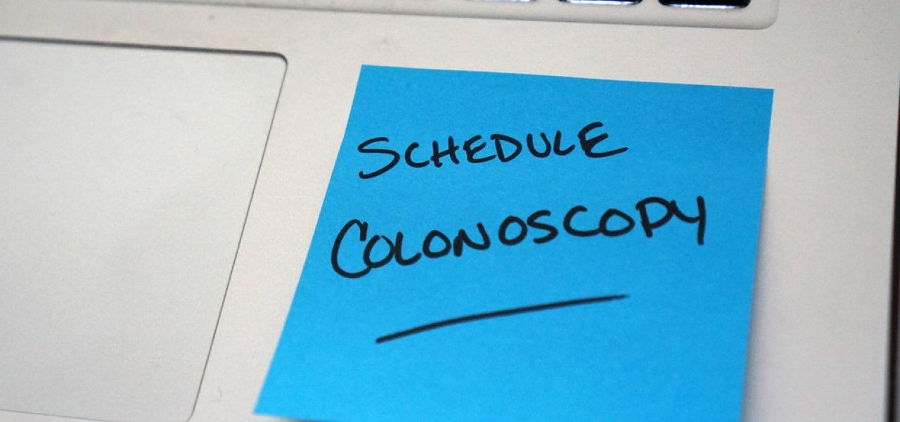 post it on a laptop with a message reminding the user to schedule a colonoscopy